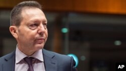 FILE - Greece's Finance Minister Yannis Stournaras arrives for a meeting of EU finance ministers at the European Council building in Brussels, May 6, 2014. 