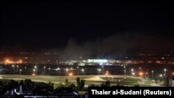 Smoke rises over Erbil, Iraq, after reports of mortar shells landing near Erbil airport, February 15, 2021.