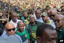 FILE - Former South African President Jacob Zuma, center, arrives at Orlando Stadium in Soweto, Johannesburg, South Africa, for a campaign event on May 18, 2024. Although he cannot run for parliament himself, he leads the Umkhonto we Sizwe party.