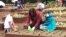 First lady Michelle Obama is joined by school children as they plant items in the White House Kitchen Garden.