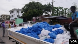 As part of measures by the Ghanaian government, food packages are distributed by members of a church to households in Ghana's capital Accra. (Stacey Knott/VOA)