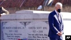 President Joe Biden walks away after a wreath laying at the tomb of the Rev. Martin Luther King Jr., and his wife, Coretta Scott King, Jan. 11, 2022, in Atlanta.