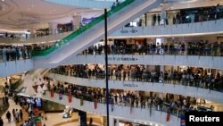 Anti-government protesters stage a rally at a shopping mall in Hong Kong.