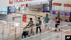 Passengers approach gate security for flights out of Love Field in Dallas, Wednesday, June 24, 2020. New York, Connecticut and New Jersey asked Wednesday for travelers from states with high coronavirus infection rates to go into quarantine for 14 days.