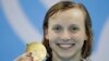 United States' Katie Ledecky shows off her gold medal after setting a new world record in the women's 400-meter freestyle final during the swimming competitions at the 2016 Summer Olympics, Aug. 8, 2016, in Rio de Janeiro, Brazil. 