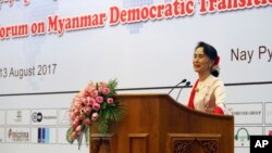 Myanmar's State Counselor Aung San Suu Kyi delivers an opening speech during the Forum on Myanmar Democratic Transition at Myanmar International Convention Center in Naypyitaw, Myanmar, Aug 11, 2017.