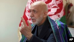 FILE - Former Afghan President Hamid Karzai speaks in Kabul, Afghanistan, April 17, 2017. 