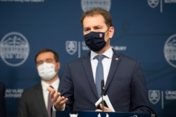 Prime Minister Igor Matovic, front, announces the resignation of Health Minister Marek Krajci, left, in Bratislava, March 11, 2021.
