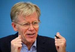 Bruce Aylward, International team lead for the WHO-China joint mission on COVID-19 coronavirus attends a news conference in Geneva, Switzerland, Feb. 25, 2020.