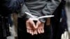 FILE - A subject stands in plastic handcuffs after being arrested by New York City Police in this November 17, 2011.