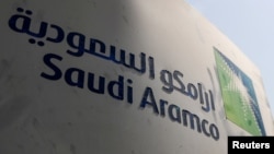 FILE - Saudi Aramco logo is pictured at the oil facility in Khurais, Saudi Arabia, Oct. 12, 2019. 