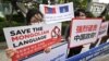 FILE - People hold placards reading "Save the Mongolian language" during a rally denouncing China’s plan to introduce Mandarin-only classes at schools in Inner Mongolia, a semi-autonomous region in China, on a street near the Chinese Embassy in Seoul, South Korea, Sept. 24, 2020.