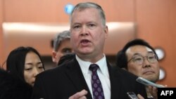 U.S. special representative on North Korea Stephen Biegun, center, speaks to reporters as his South Korean counterpart Lee Do-hoon, right, looks on after their "working group" meeting handling North Korean issues at the Foreign Ministry in Seoul on Dec.