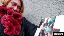 Kobe Bryant's childhood friend Alessia Pierattini cries as she looks at some pictures of Kobe Bryant's first communion, in Cireglio, Italy, Jan. 27, 2020.