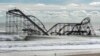 November 1, 2012: The remnants of a roller coaster sits in the surf three days after Hurricane Sandy came ashore in Seaside Heights, New Jersey.