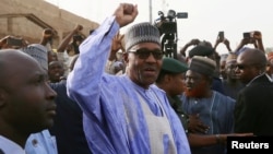 FILE - Nigerian President Muhammadu Buhari gestures as he arrives to cast a vote in Nigeria's presidential election at a polling station in Daura, Katsina State, Nigeria, Feb. 23, 2019.
