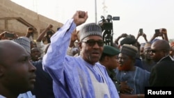 FILE - Nigerian President Muhammadu Buhari gestures as he arrives to cast a vote in Nigeria's presidential election at a polling station in Daura, Katsina State, Nigeria, Feb. 23, 2019.