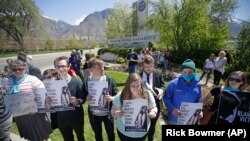 Protesters stand in solidarity with rape victims on the campus of Brigham Young University during a sexual assault awareness demonstration, in Provo, Utah.
