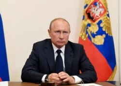 Russian President Vladimir Putin, addresses the nation via video conference at the Novo-Ogaryovo residence outside Moscow, Russia, May 11, 2020.