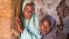 Aisha Amiru (with green hijab) said she and her younger sister look forward to getting married in a few years. (C. Oduah/VOA)