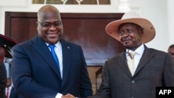 President of Democratic Republic of Congo (DRC) Felix Tshisekedi (L) shakes hands with Uganda's President Yoweri Museveni upon his arrival to discuss business between the two countries at the state house in Entebbe, Uganda, Nov. 9, 2019. 