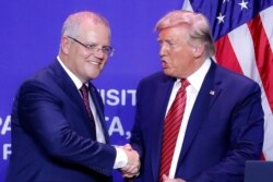 President Donald Trump, right, and Australian Prime Minister Scott Morrison shake hands after speaking the opening of an Australian-owned Pratt Industries plant, Sept. 22, 2019, in Wapakoneta, Ohio.