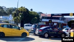 FILE - People queue up for takeaway food as the nationwide coronavirus disease (COVID-19) lockdown eases in Wellington, New Zealand, Sept. 1, 2021.
