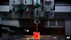 A 3D printer prints a heart with human tissue during a presentation at the University of Tel Aviv, in Tel Aviv, Israel, Monday, April 15, 2019. (AP Photo/Oded Balilty)