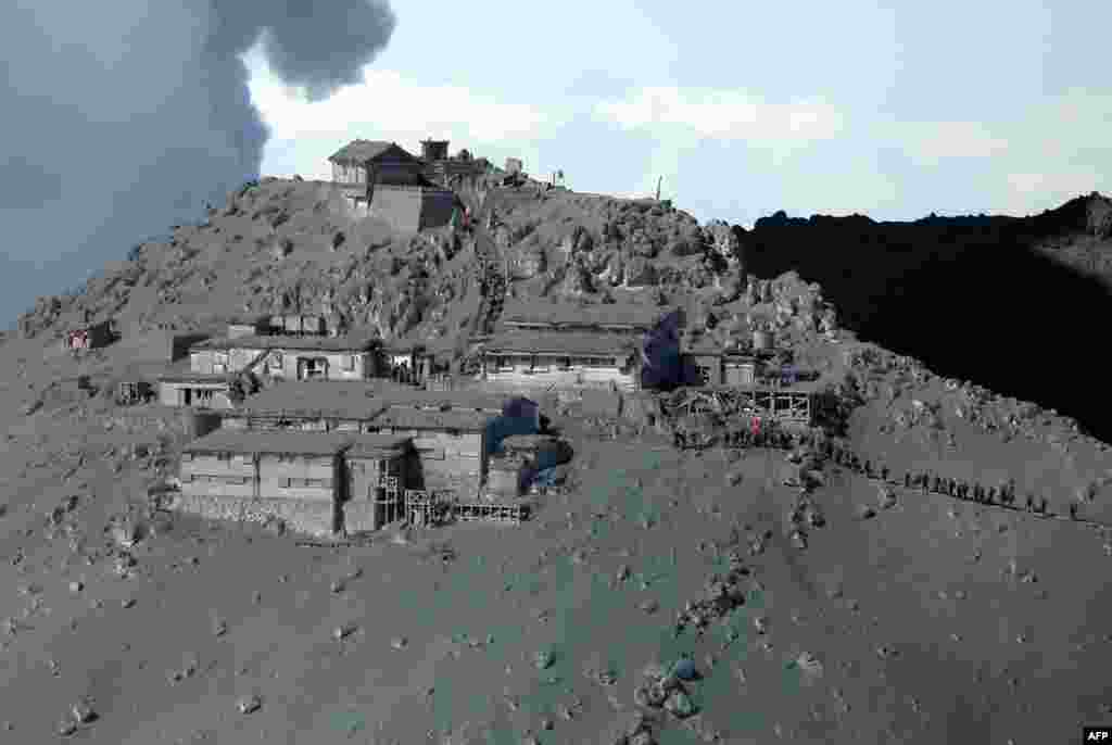 Foto yang diambil dari udara ini memperlihatkan aktivitas regu penyelamat dan para anggota&nbsp;Pasukan Bela Diri Jepang (JSDF)&nbsp;dalam operasi pencarian korban erupsi gunung Ontake,&nbsp;di antara timbunan debu yang menyelimuti desa-desa dan sebuah kuil Shinto&nbsp;di wilayah Nagano, Jepang (28/9). 