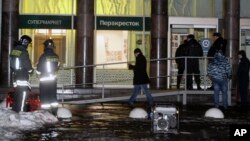 Police stand at the entrance of a supermarket, after an explosion in St. Petersburg, Russia, Dec. 27, 2017. 
