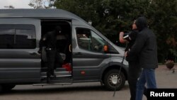 Law enforcement officers detain a journalist in central Minsk, Belarus, August 27, 2020.