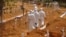 Health workers walk inside a new graveyard as they move bury people suspected of dying from the Ebola virus on the outskirts of Monrovia, Liberia, Wednesday, March 11, 2015. Liberians held a church service Wednesday for families who lost members to Ebola to mark the country’s 99th celebration National Decoration Day, a holiday normally set aside for people to clean up and re-decorate the graves of their lost relatives. (AP Photo/Abbas Dulleh)