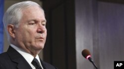 Defense Secretary Robert Gates gestures while speaking at the American Enterprise Institute for Public Policy Research in Washington, Tuesday, May 24, 2011