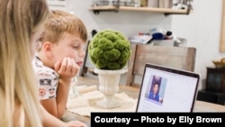 Mom uses telemedicine to talk with Dr. William Chu, medical director of the NightLight Pediatric Urgent Care clinics, Houston, Texas. (Photo courtesy Elly Brown)