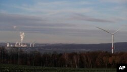 Smoke rises from chimneys of the Turow power plant located by the Turow lignite coal mine near the town of Bogatynia, Poland, Nov. 19, 2019. 