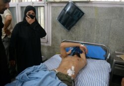 A man lies in a hospital bed after being shot with pellets during clashes between Indian police and those protesting the Indian government's scrapping of Kashmir's special status, in Srinagar, Aug. 9, 2019.