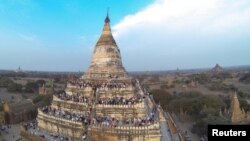 People wait to see the sunset from the top of Shwesandaw Pagoda in the ancient city of Bagan February 13, 2015. REUTERS/Soe Zeya Tun