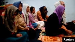 Soldiers carry guns during a clash with protesters demonstrating against the military coup in Mandalay, Myanmar.