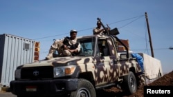 Army soldiers guard a checkpoint outside Amran city, north of Sanaa, amid tension with Shiite Houthi militants on April 13, 2014. 