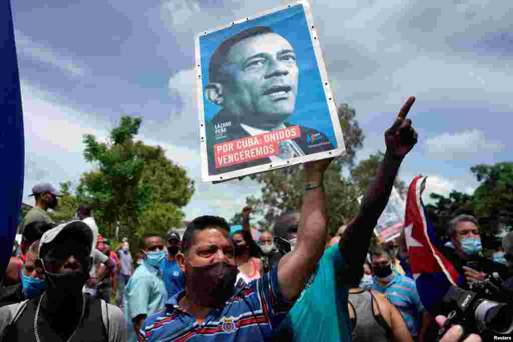 People shout slogans in support of the government as Cuba&#39;s President Miguel Diaz-Canel (not pictured) talks to the media, in San Antonio de los Banos, Cuba, July 11, 2021. 