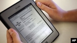 FILE - In this Aug. 5, 2013, file photo, a Kindle reading device displays articles from The Washington Post.