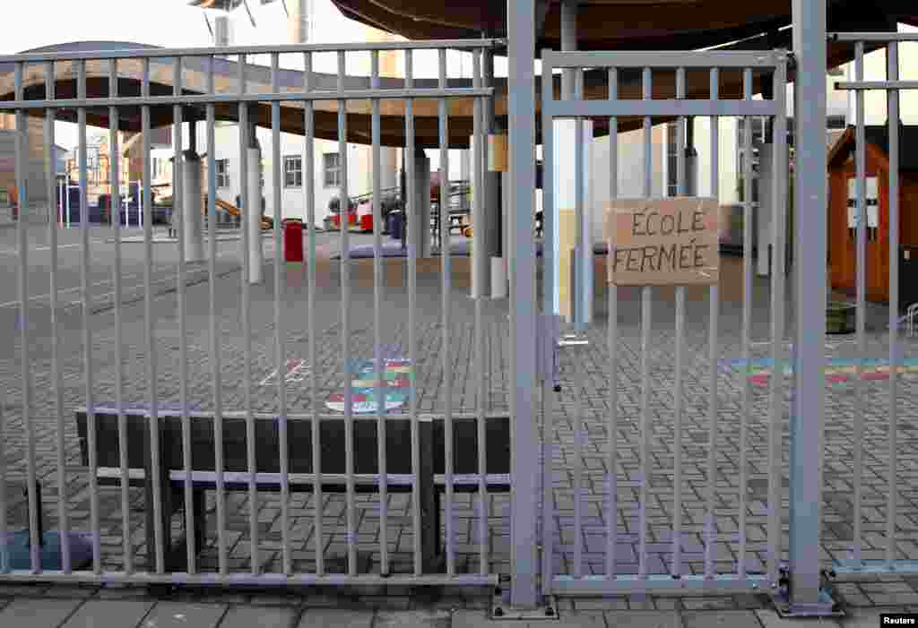 A sign that reads &quot;school closed&quot; is pictured at the entrance of a primary and nursery school in Brussels, Nov. 23, 2015, after security was tightened in Belgium following the fatal attacks in Paris.