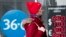 RUSSIA -- A woman walks past an exchange office screen showing the currency exchange rates of U.S. Dollar and Euro to Russian Rublel in Moscow, March 9, 2020