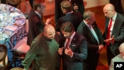 Ukraine's Minister of Defense Rustem Umerov, center left, talks with Slovakia's Republic's Minister of Defense Robert Kaliňák, center right, during a social dinner at Fort McNair for defense ministers attending the NATO summit on July 10, 2024 in Washington.