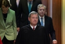 Chief Justice John Roberts, followed by Sen. Dianne Feinstein, D-Calif., left, and Senate Judiciary Committee Chairman Lindsey Graham, R-S.C., leaves the Senate chamber after presiding over the impeachment trial and the acquittal of President Donald…