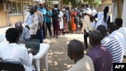 FILE - Residents wait in line to register to receive their first dose of the AstraZeneca COVID-19 vaccine, during a vaccination drive at the Dandora Health Center in Nairobi, Kenya, Aug. 10, 2021.