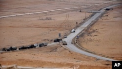 In this photo released by the Syrian official news agency SANA, Syrian forces take up positions during fighting between Government forces and Islamic State group militants in the ancient city of Palmyra, near Homs, Syria, Thursday, March 2, 2017