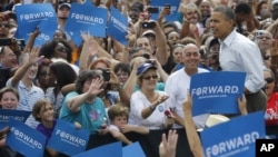 President Barack Obama walks on stage as he is introduced at a campaign event at St. Petersburg College-Seminole Campus at the Natural Habitat Park Field, Saturday, Sept. 8, 2012, in St. Petersburg, Florida.