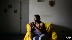 Luber Faneitte, a 56-year-old diagnosed with lung cancer, talks during a interview with AFP at her house in the San Agustin shantytown in Caracas on Nov. 10, 2017. Faneitte fears that if Venezuela defaults on its $150 billion debt, which is considered lik