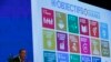 FILE - The 17 goals of the 2030 Agenda for Sustainable Development are seen behind then-U.N. Secretary-General Ban Ki-Moon at the Annual Conference of Swiss Development Cooperation in Zurich, Switzerland, Jan. 22, 2016.
